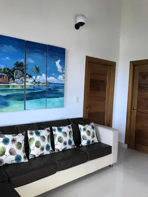 a living room with a black and white couch at casita del padre pio in Punta Rucia