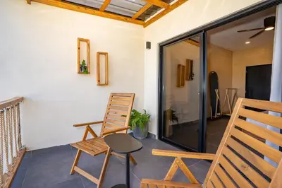 a patio with two chairs and a table at VillaVida Boutique Hotel - La Playita in Las Galeras