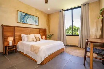 a bedroom with a bed and a large window at VillaVida Boutique Hotel - La Playita in Las Galeras