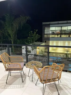 a group of chairs and tables on a patio at modern y acogedor in San Felipe de Puerto Plata