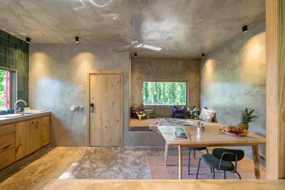 a bedroom with a bed and a table in a room at REFUGIO Nature meets Luxury in Sabaneta de Yásica