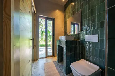 a bathroom with a toilet and a sink at REFUGIO Nature meets Luxury in Sabaneta de Yásica