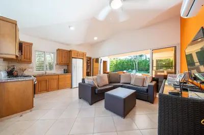 a living room with a couch and a kitchen at Casa Linda Villa 918 - Sosua in Sosúa