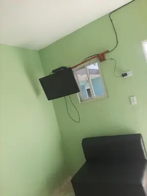 a green room with a window and a lamp on the wall at Tarde trankila in Sabana de Nisibón