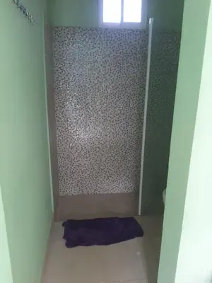 a small bathroom with a shower with a purple towel at Tarde trankila in Sabana de Nisibón