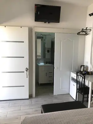 a room with a door with a television on the wall at Bayahibe Apartments in Bayahibe