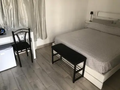 a bedroom with a bed and a chair and a desk at Bayahibe Apartments in Bayahibe
