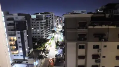 a view of a city street at night with buildings at Lindo 1BD apt in Bella Vista with Pool, Rooftop,Gym,Parking in Santo Domingo