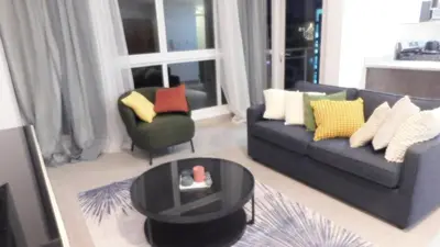 a living room with a couch and a table at Lindo 1BD apt in Bella Vista with Pool, Rooftop,Gym,Parking in Santo Domingo