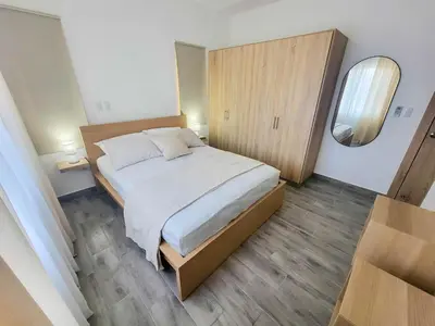 a bedroom with a large bed and a mirror at Lovely Condo in Gated Community in Sosúa