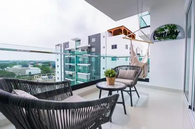 a room with chairs and a table and a window at Modern 3BR! 9fl, King Bed! Sti!, in Santiago de los Caballeros