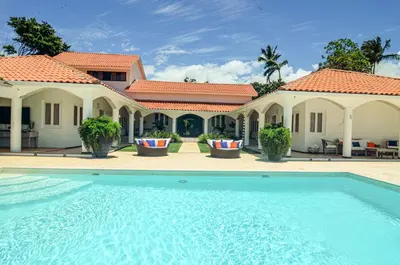 a swimming pool in front of a house at Cacique 13, Ocean View and Golf Course in La Romana