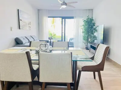 a dining room with a dining table and chairs at Dream pool views apartment close to the beach in Punta Cana