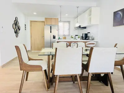 a kitchen and dining room with a table and chairs at Dream pool views apartment close to the beach in Punta Cana