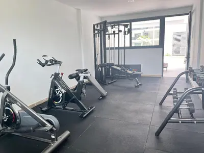 a gym with several tread machines in a room at Dream pool views apartment close to the beach in Punta Cana
