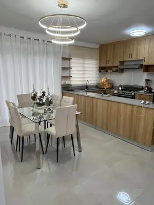 a dining room and kitchen with a table and chairs at Legado Edif V Apto A2 in Azua de Compostela