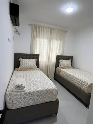 two beds sitting next to each other in a room at Legado Edif V Apto A2 in Azua de Compostela