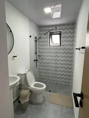 a bathroom with a toilet and a sink at Legado Edif V Apto A2 in Azua de Compostela