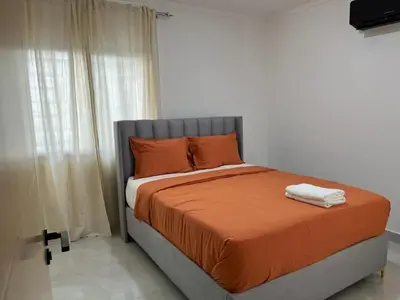 a bed with two towels on it in a bedroom at Legado Edif V Apto A2 in Azua de Compostela