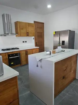 a kitchen with a large white island in a kitchen at Andys Villa in Naime 3 in San Pedro de Macorís