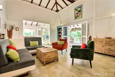 a living room with couches and chairs and a table at Casa Zebra lovely villa near the beach in Las Terrenas