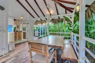 a dining room with a wooden table and chairs at Casa Zebra lovely villa near the beach in Las Terrenas