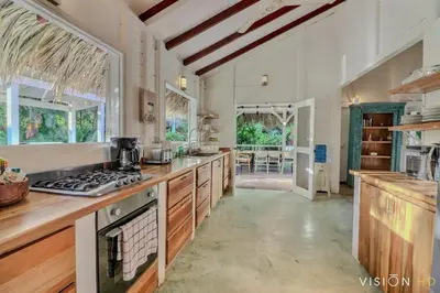a large kitchen with wooden counters and a stove top oven at Casa Zebra lovely villa near the beach in Las Terrenas