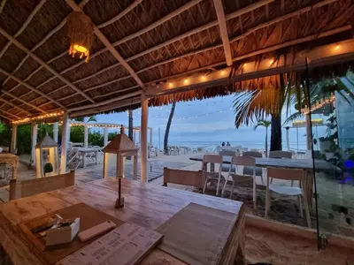 a restaurant with a table and a view of the beach at Backyard, Pool View, Walk to Beach, Dining, Shops in Punta Cana