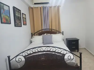 a bedroom with a large bed with a wooden frame at Fantastic apartment 1Rooms zona colonial in Santo Domingo