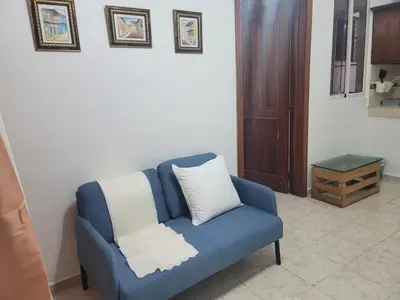 a blue couch with a white pillow in a room at Fantastic apartment 1Rooms zona colonial in Santo Domingo