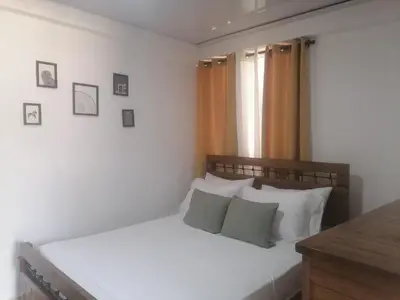 a bedroom with a bed with white sheets and pillows at Fantastic apartment 1Rooms zona colonial in Santo Domingo