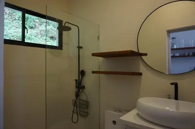 a bathroom with a shower and a sink and a mirror at Yara-ri Apartaments in La Majagua