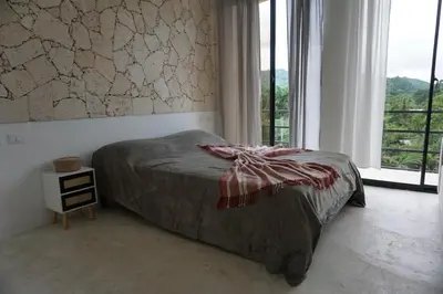 a bedroom with a bed and a large window at Yara-ri Apartaments in La Majagua