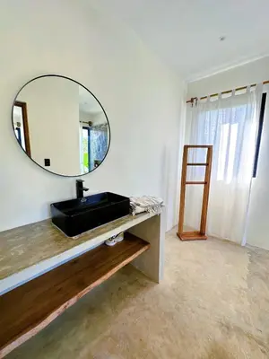 a bathroom with a sink and a mirror on the wall at Casa Ola, luxurious jungle house in El Valle