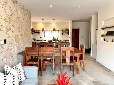 a kitchen and dining room with a wooden table and chairs at Casa Ola, luxurious jungle house in El Valle