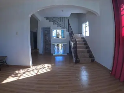 a hallway with a staircase in a house at Hotel Mi Propio Esfuerzo in Vicente Noble