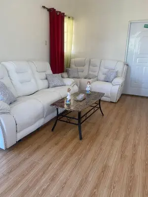 a living room with a white couch and a coffee table at Hotel Mi Propio Esfuerzo in Vicente Noble