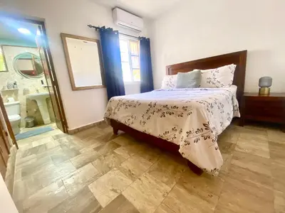 a bedroom with a large bed and a mirror at Paradise Arenas De Bávaro RD in Punta Cana