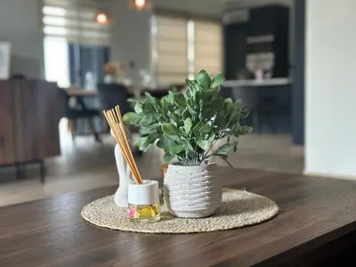 a vase with a plant on a table with chopsticks at Ester house Sabaneta in Sabaneta