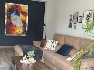 a living room with a couch and a table at Ester house Sabaneta in Sabaneta