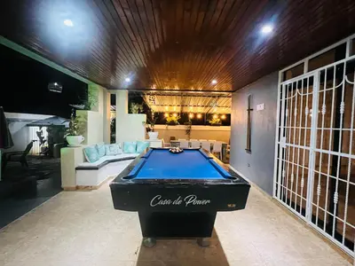 a pool table in the middle of a room at Casa en río san Juan 4 habitaciones in Río San Juan