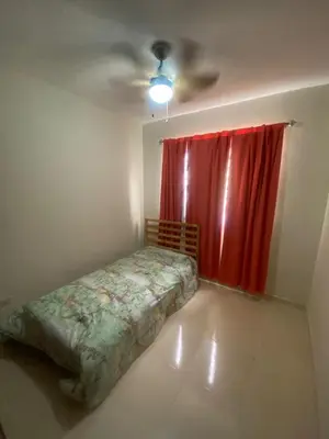 a bedroom with a bed and a red curtain at Como apartamento in La Javilla