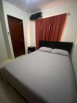 a bedroom with a large bed with a red curtain at Como apartamento in La Javilla