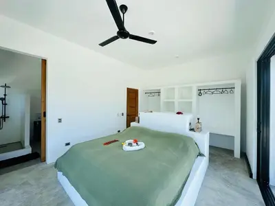 a bedroom with a bed with a ceiling fan at Casa Juan Lucas in Las Galeras
