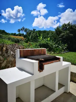 a white bench sitting on the side of a field at Casa Juan Lucas in Las Galeras
