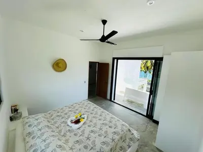 a bedroom with a bed and a ceiling fan at Casa Juan Lucas in Las Galeras