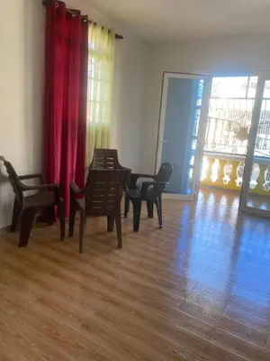 a living room with chairs and a table and a red curtain at My propio esfuerzo in Vicente Noble