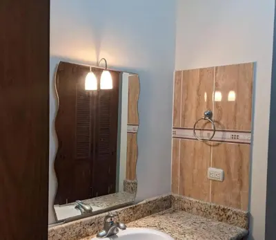 a bathroom with a sink and a mirror at Penthouse in El Cortecito in Punta Cana