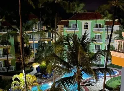 a view of a resort with a pool and palm trees at Penthouse in El Cortecito in Punta Cana