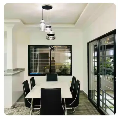 a dining room with a white table and black chairs at Villas Miranda in La Tentación
